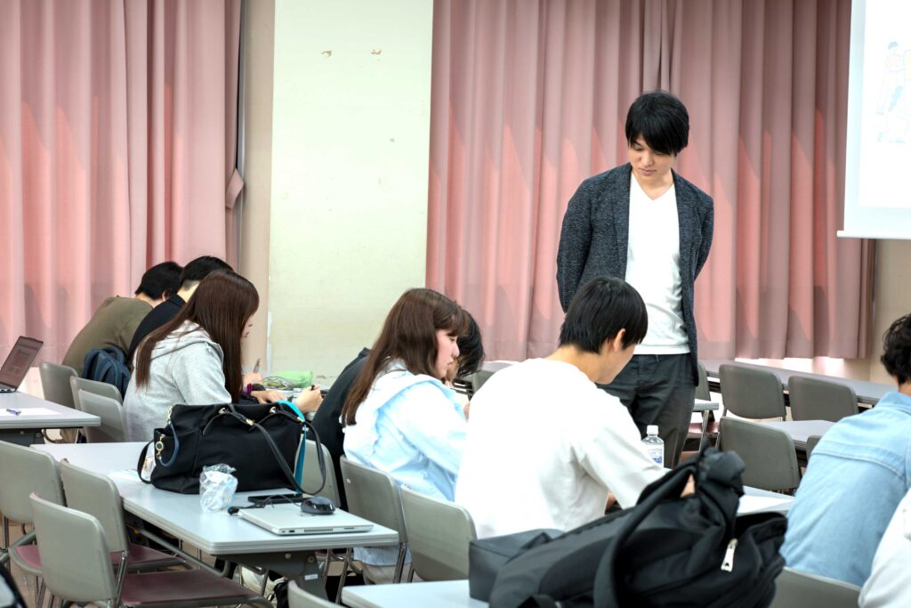白梅学園大学で行われたSTEAM教育の授業中、グループワークに取り組む学生たちと、それを見守る講師の様子